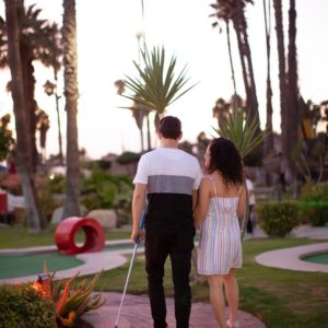 Couple on date night playing mini golf