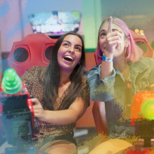 Girls playing arcade games at Fiesta Village