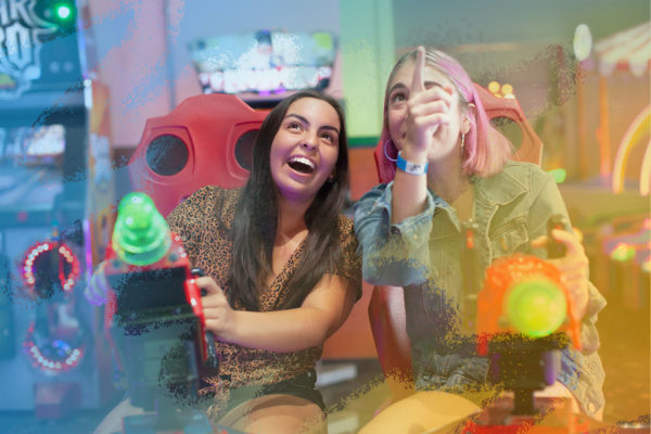 Girls playing arcade games at Fiesta Village